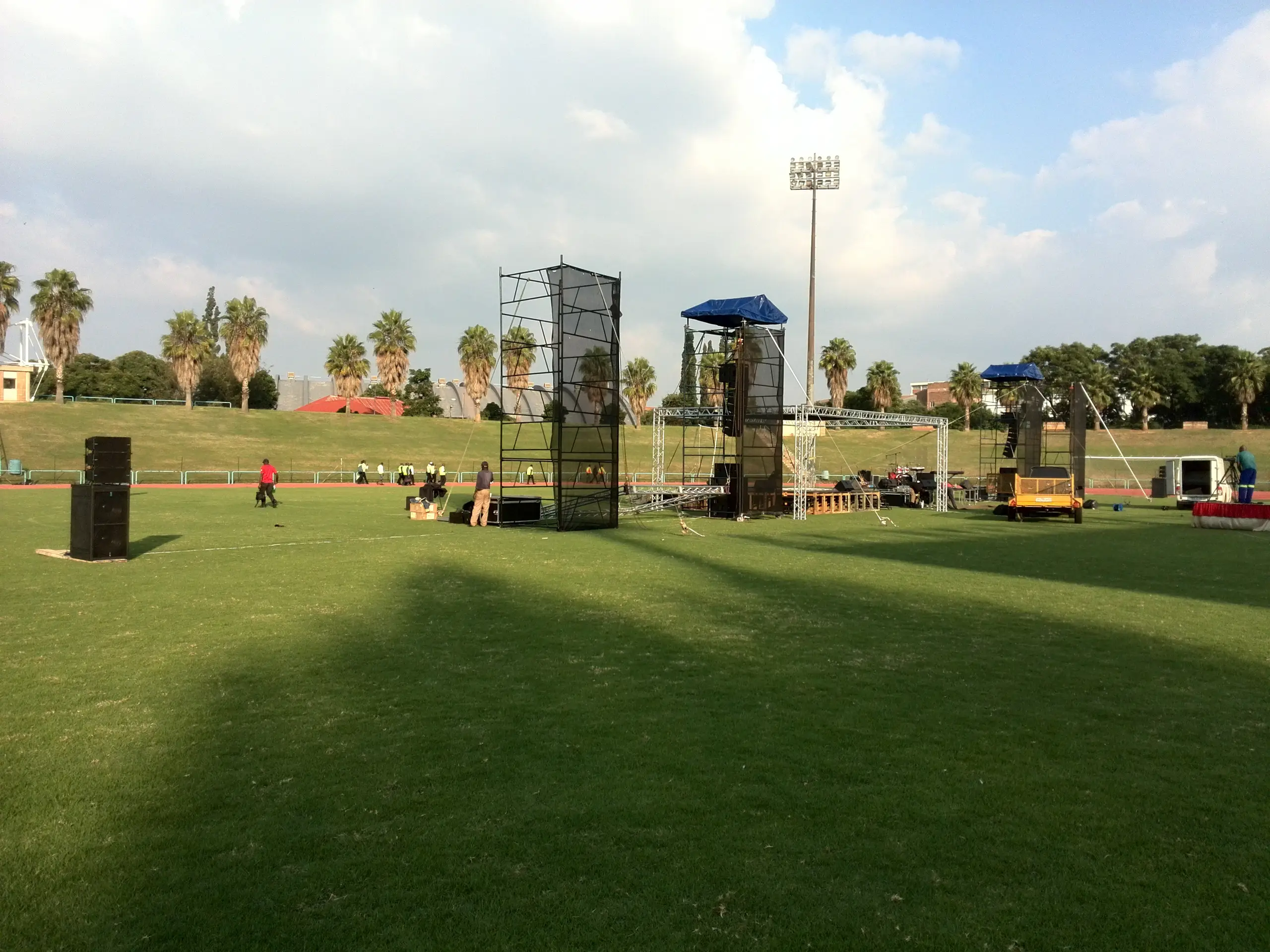 Sound towers and a stage going up on a sports field